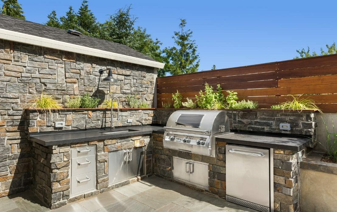 Outdoor kitchen including a grill, built into brick