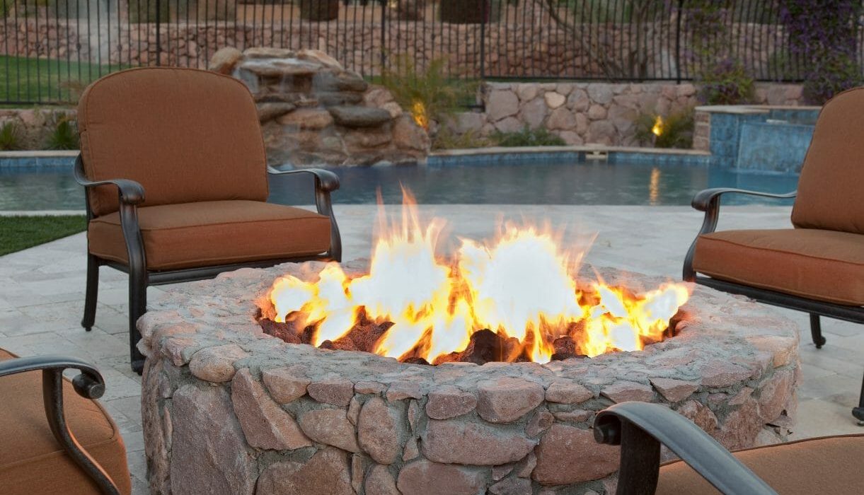 Fire burning in a backyard stone fire pit