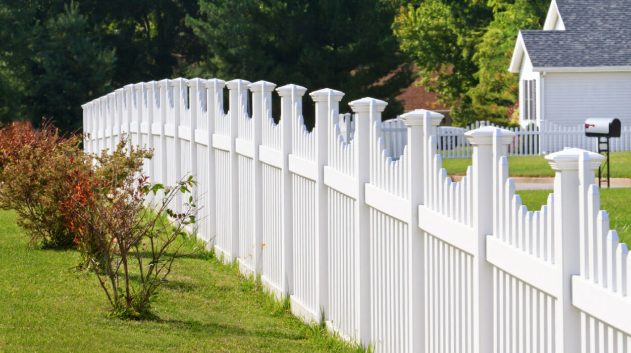Yard with a white picket fence and green grass